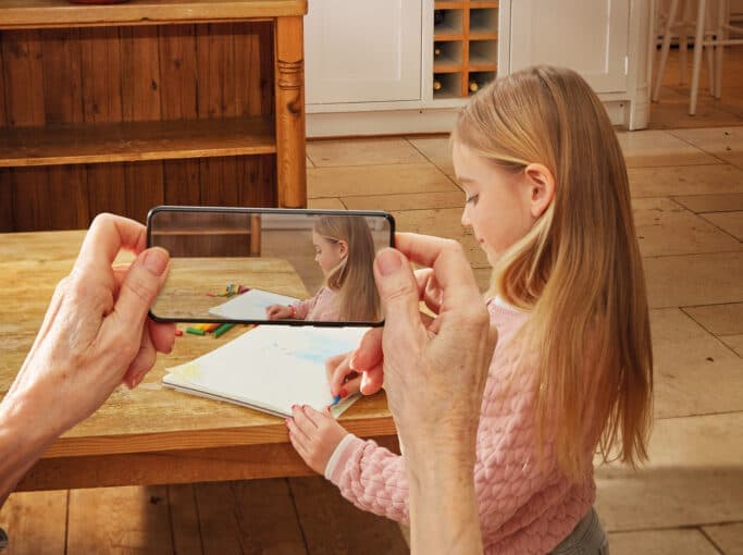 Illustration of a child writing, viewed through a RayOne Galaxy lens